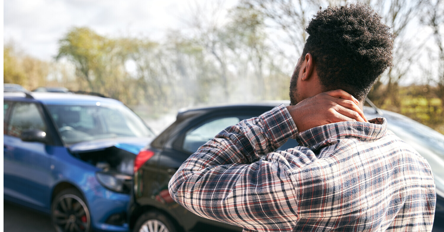Man holding neck after car accident