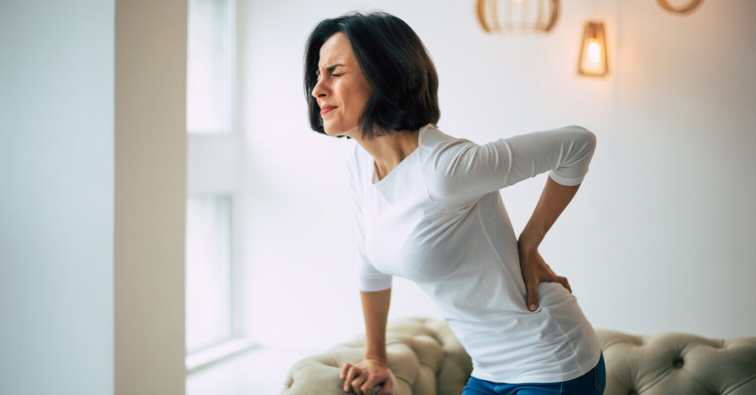 Woman with back pain when standing up
