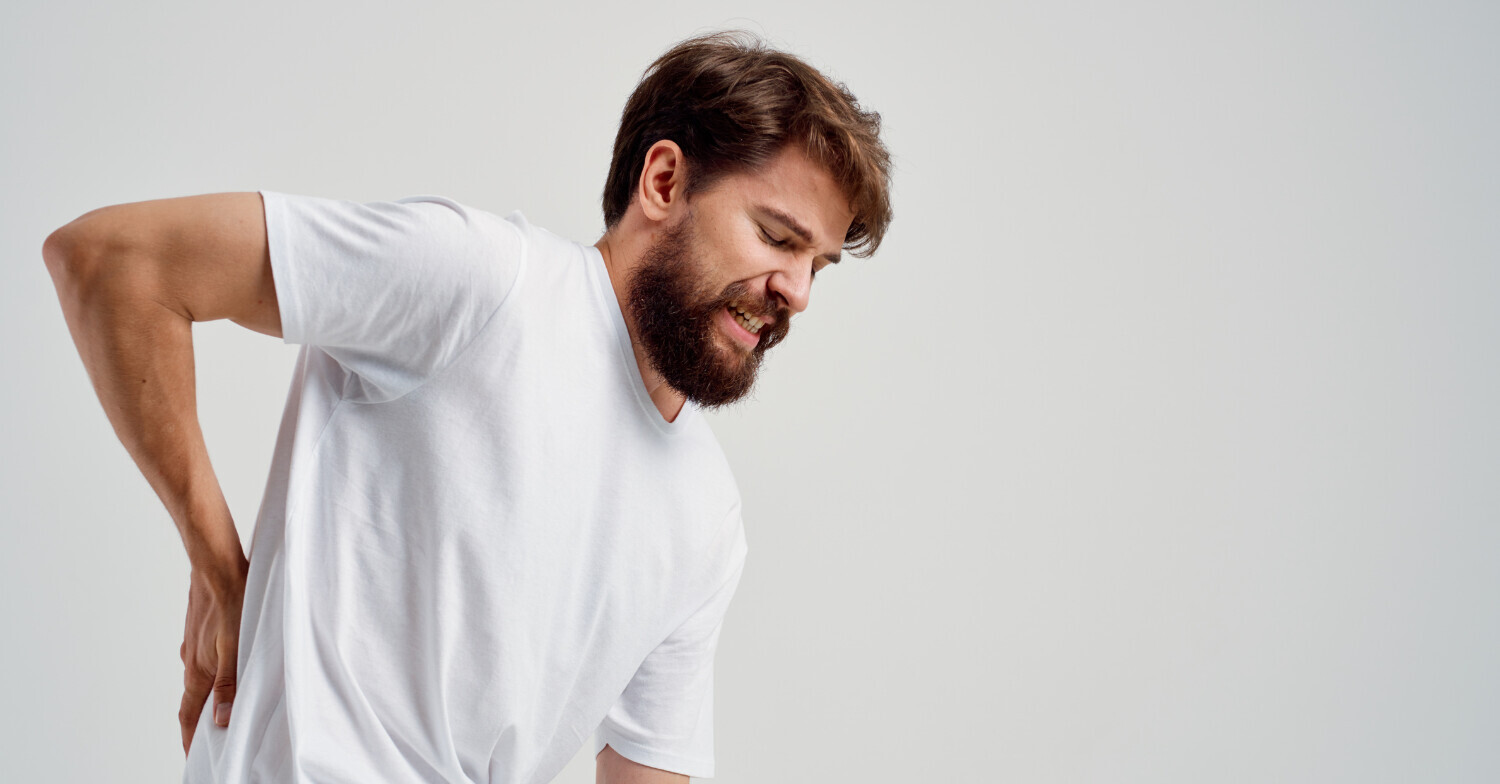 Man holding lower back due to pain