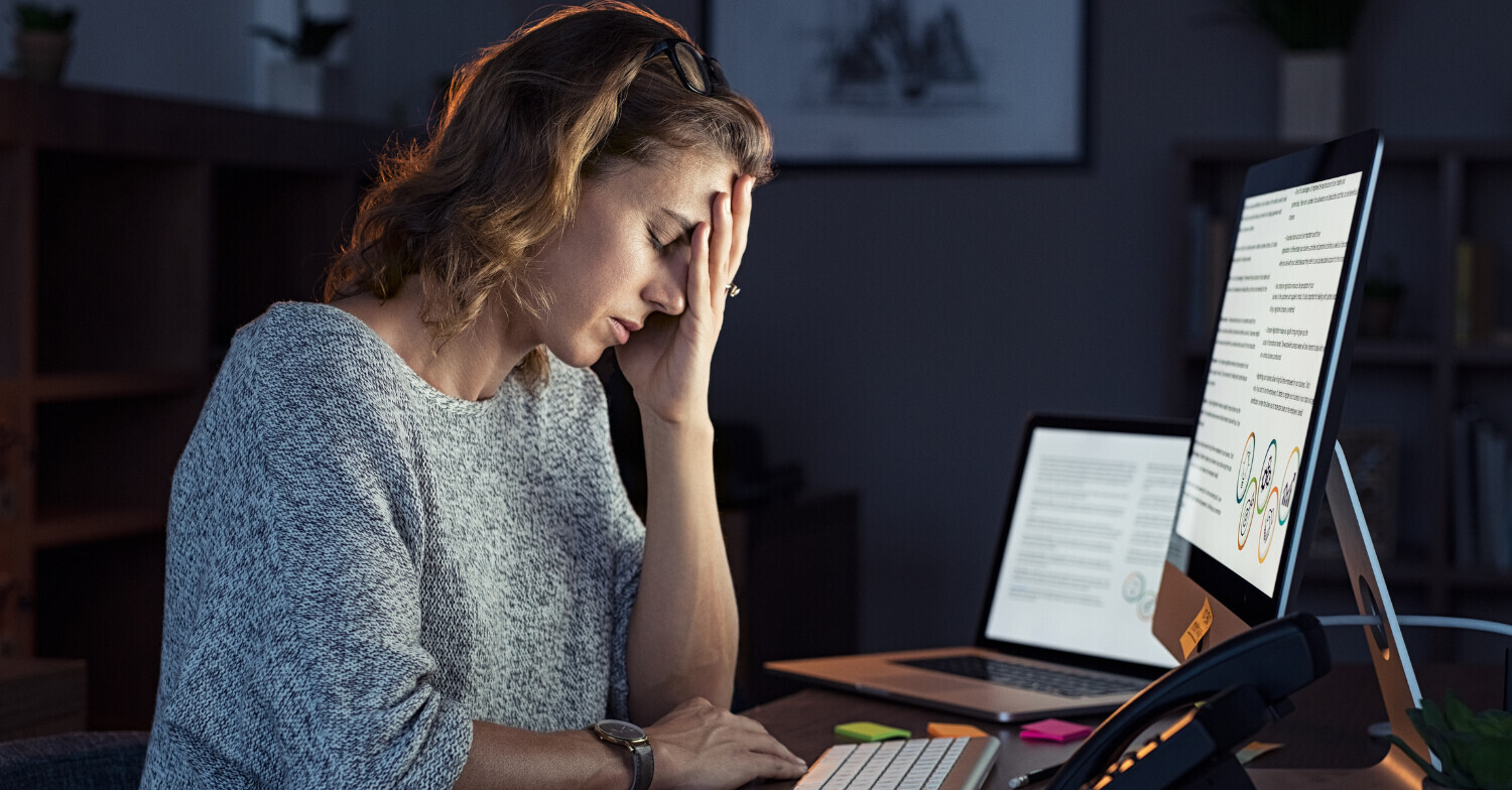 A woman feeling stressed and overwhelmed by the work she needs to get done. 
