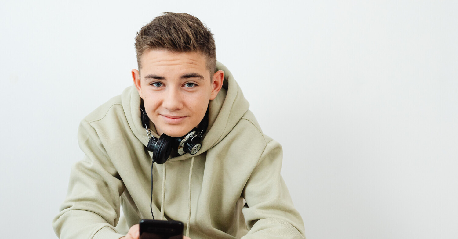 Teen with headphones and cell phone